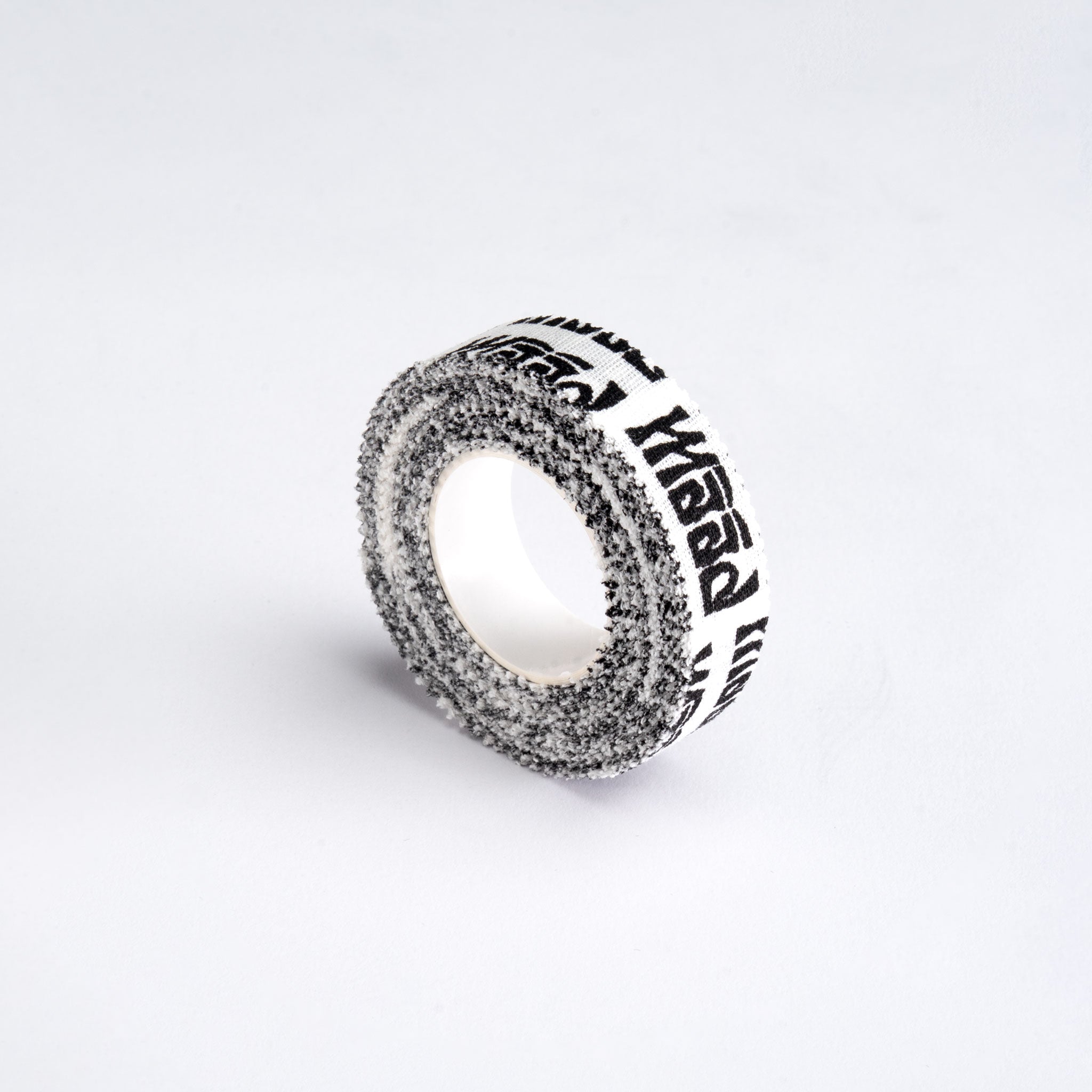 Roll of black and white tape on a light gray background
