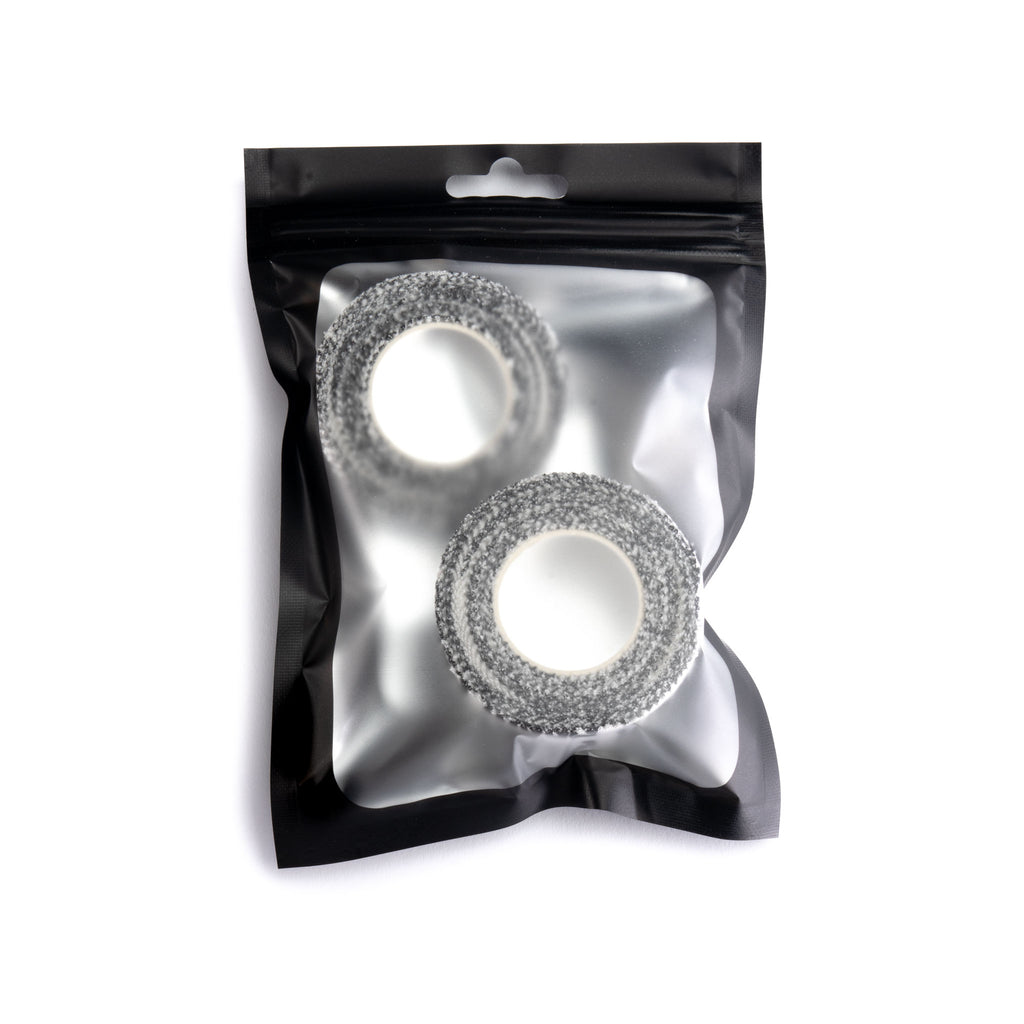 Two silver rings in a clear plastic bag with a black background