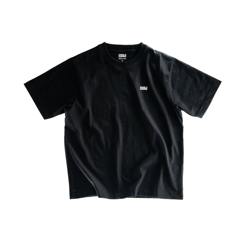 Black t-shirt with a small white logo on a white background